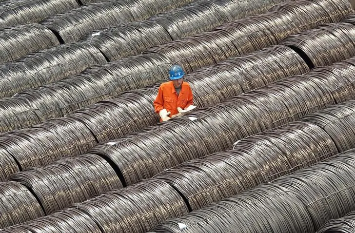 A worker checks steel wire at a warehouse in Dalian City, Liaoning Province, northern China, on May 15, 2017. (Stringer/Reuters)