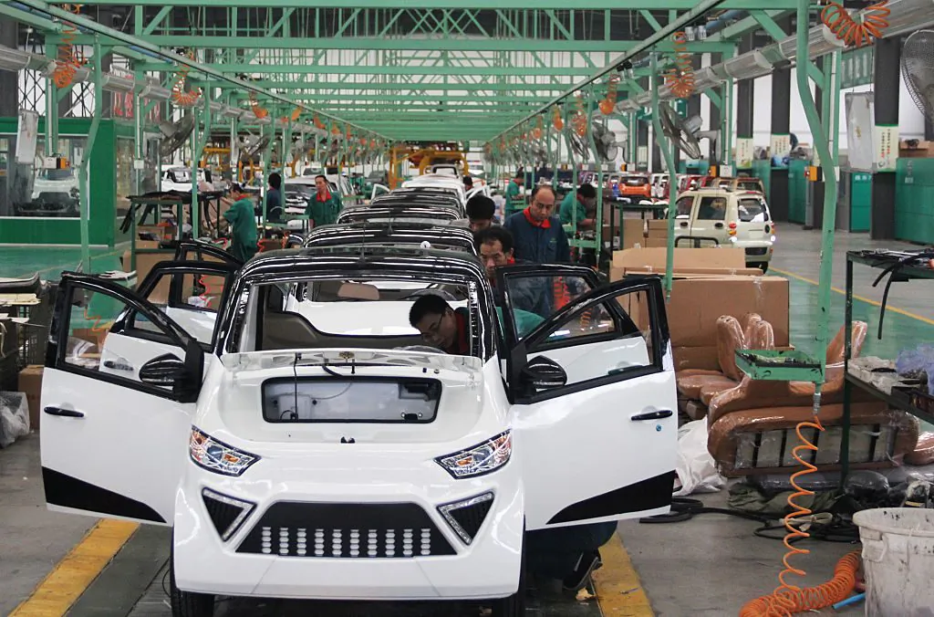 Workers assemble electric cars in a factory in Zouping, east China's Shandong Province on September 16, 2014. (AFP/AFP/Getty Images)