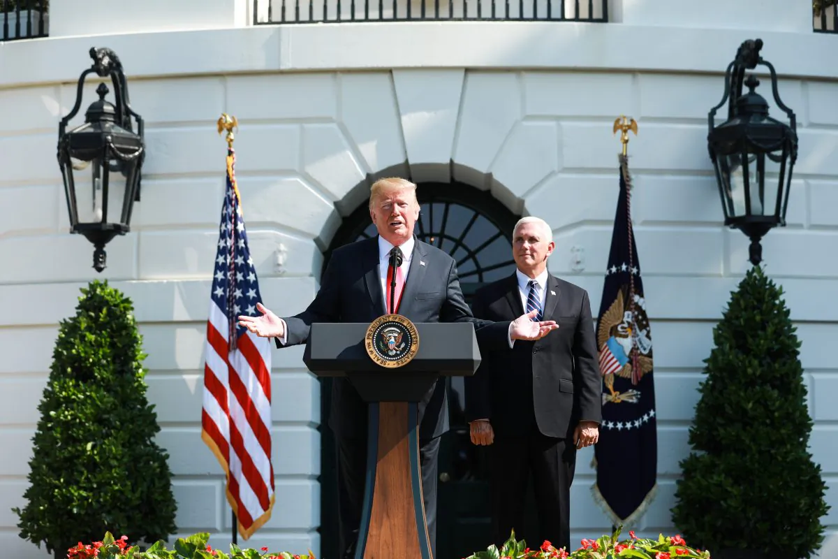 President Donald Trump delivers remarks, as Vice President Mike Pence looks on, about the economy and second quarter GDP growth of 4.1% on the South Lawn of the White House in Washington on July 27, 2018. (Samira Bouaou/The Epoch Times)