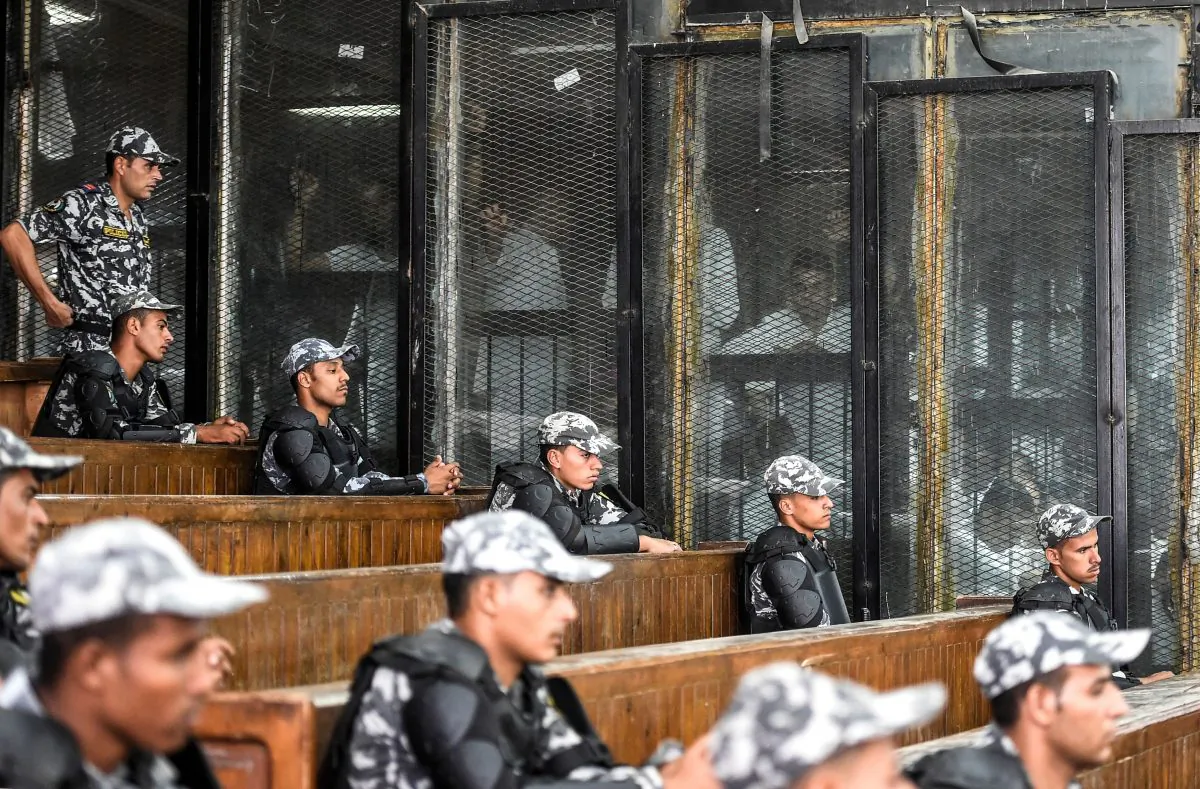 Members of Egypt's banned Muslim Brotherhood are seen inside a glass dock during their trial in the capital Cairo on July 28, 2018. (KHALED DESOUKI/AFP/Getty Images)