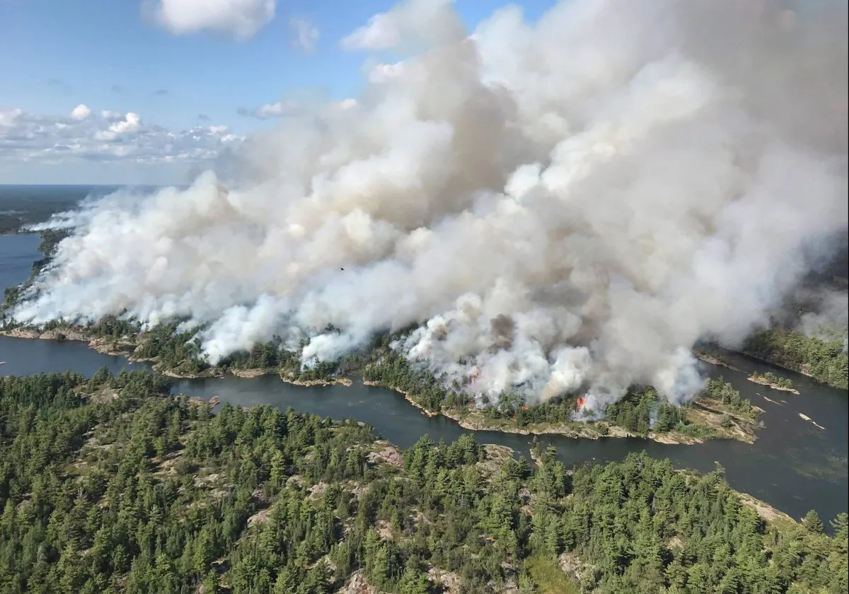An aerial view taken over the Parry Sound 33 fire is shown in this handout image. The blaze, known as Parry Sound 33, sprung up on July 18. Ontario firefighters have been fighting it with the help of their counterparts from other provinces, as well as the United States and Mexico. (The Canadian Press/HO-AFFES Ignition/Response Specialist-Dan Leonard)
