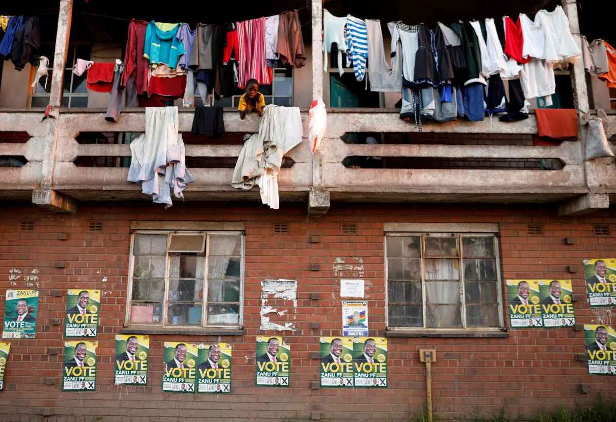 Election posters are pictured on the walls of apartments in Mbare township in Harare, Zimbabwe, July 29, 2018. (Reuters/Mike Hutchings)