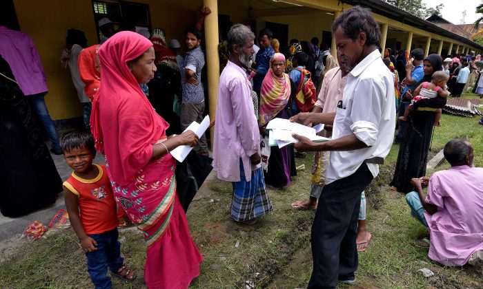 Villagers wait outside the National Register of Citizens (NRC) centre to get their documents verified by government officials, at Mayong Village in Morigaon district, in the northeastern state of Assam, India July 8, 2018. (Reuters/Stringer)