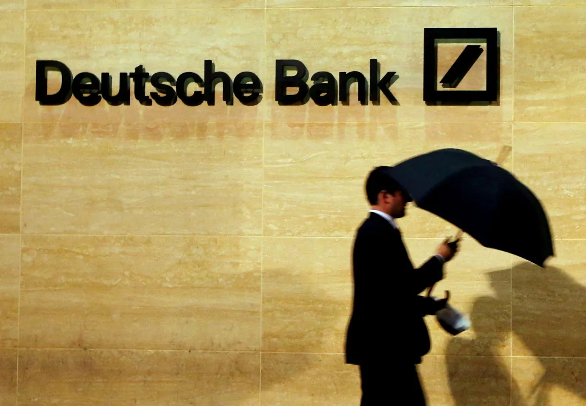 A man walks past Deutsche Bank offices in London, Britain, December 5, 2013. (Reuters/Luke MacGregor/File Photo)