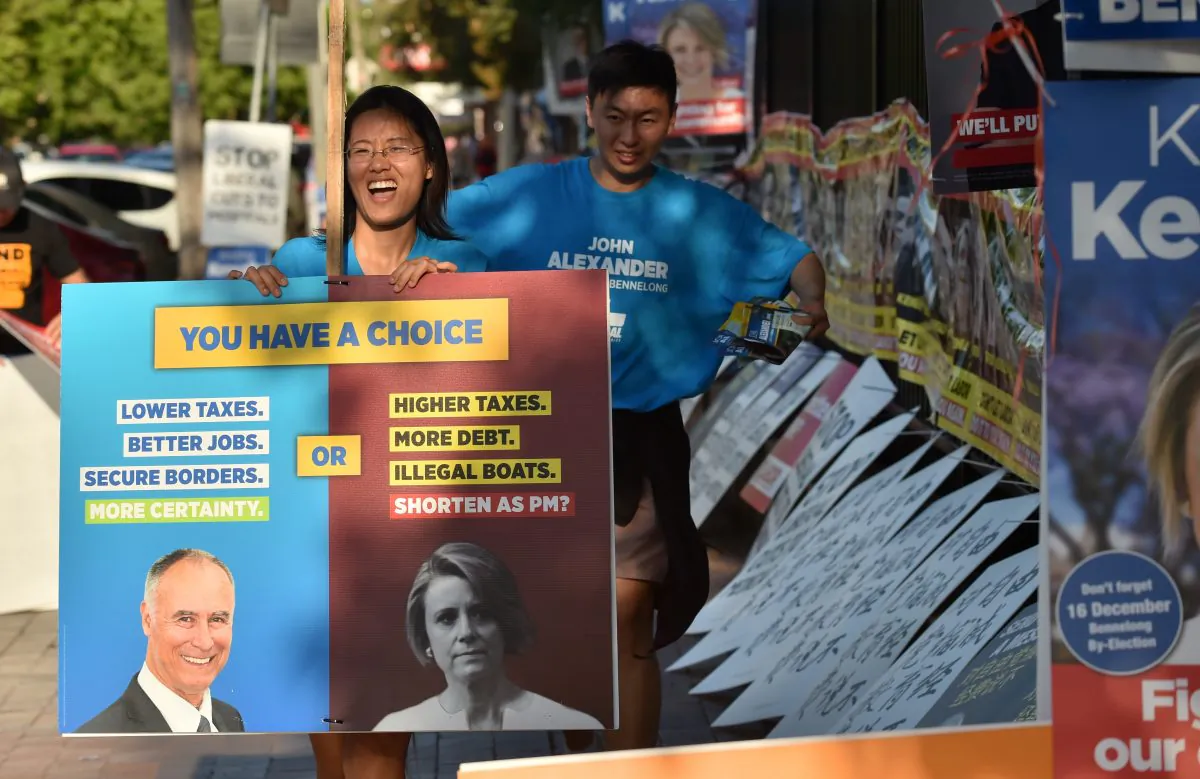 Supporters of Liberal MP John Alexander pack away banners outside a polling station at the close of voting in the suburban Sydney seat of Bennelong on Dec. 16, 2017. Electoral pressure by the Chinese Communist Party almost toppled the Australian government. (PETER PARKS/AFP/Getty Images)