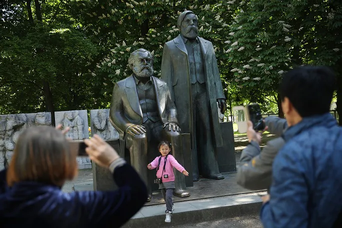 Visitors from China photograph one another in front of a statue of philosopher and revolutionary Karl Marx on May 4, 2018 in Berlin, Germany. Marx’s 200th birthday was May 5, 2018. (Sean Gallup/Getty Images)