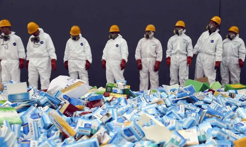 Chinese workers preparing to destroy fake medicines seized in Beijing, on March 14, 2013. The U.S. Food and Drug Administration announced on July 13, 2018 the recall of the heart medicine valsartan, made by Chinese firm Zhejiang Huahai, which was found to be contaminated by a carcinogen. (STR/AFP/Getty Images)
