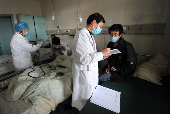 Chinese medical personnel attend to swine flu patients at a hospital in Hefei, eastern China's Anhui Province on November 25, 2009. (STR/AFP/Getty Images)