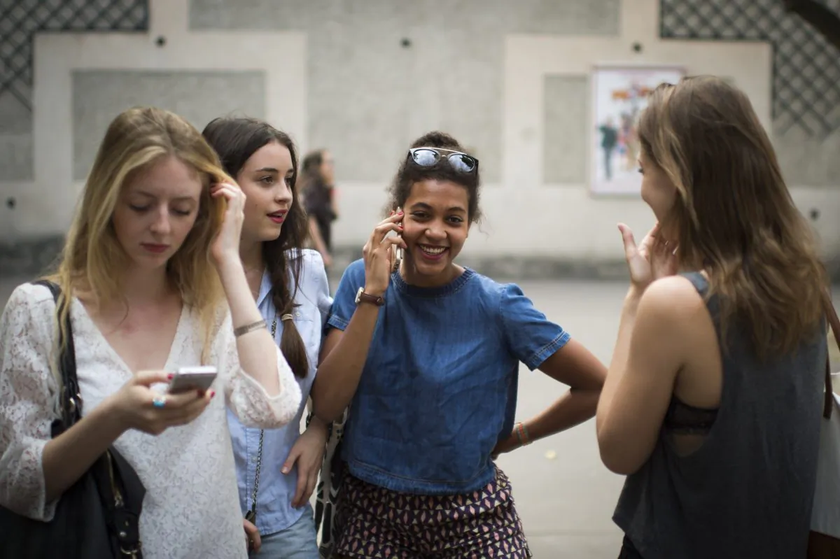 Students in France use their cellphones after viewing the results of the baccalaureat exam (high school graduation exam) on July 7, 2015 at the Georges Brassens secondary school in Paris. (Martin Bureau/AFP/Getty Images)