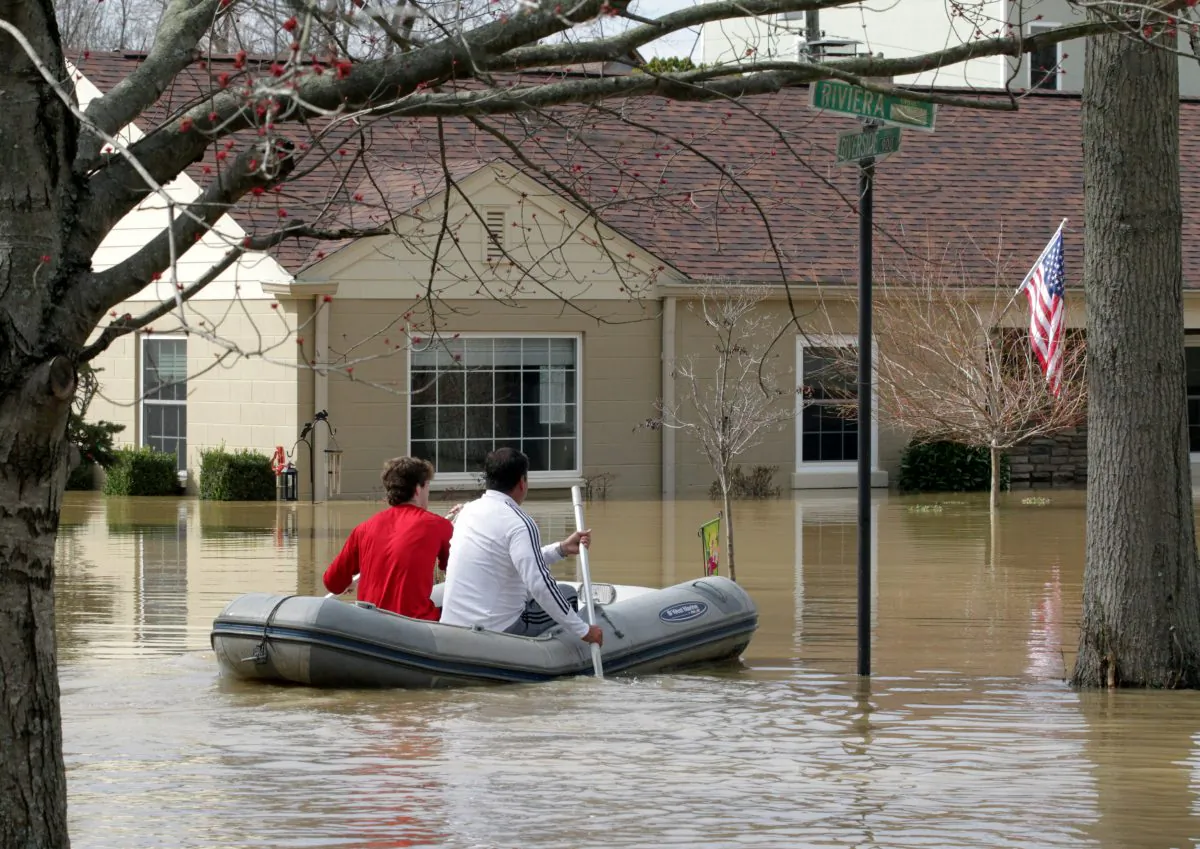 Louisville residents use boats and kayaks to get to their homes along the Ohio River after it flooded Louisville, Kentucky, on Feb. 25. (REUTERS/John Sommers II)