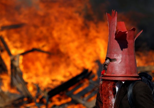 A supporter of the opposition Movement for Democratic Change party (MDC) of Nelson Chamisa wears a cone as they block a street in Harare, Zimbabwe, August 1, 2018. (Reuters/Siphiwe Sibeko)