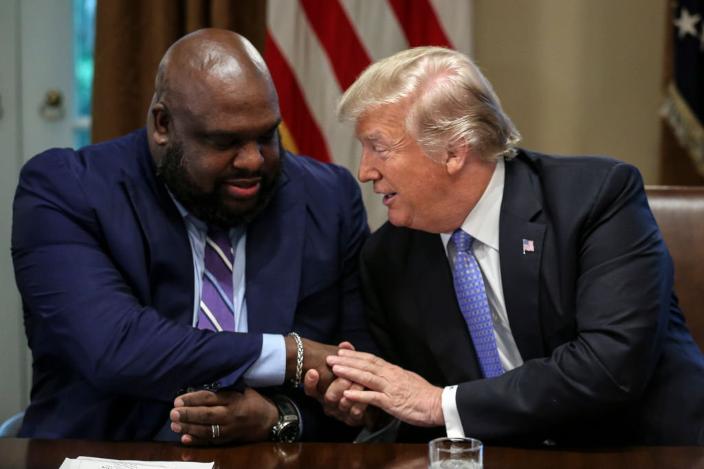 President Donald Trump shakes hands with Senior pastor John Gray during a meeting with inner-city pastors in the Cabinet Room of the White House in Washington on Aug. 1, 2018. (Oliver Contreras - Pool/Getty Images)