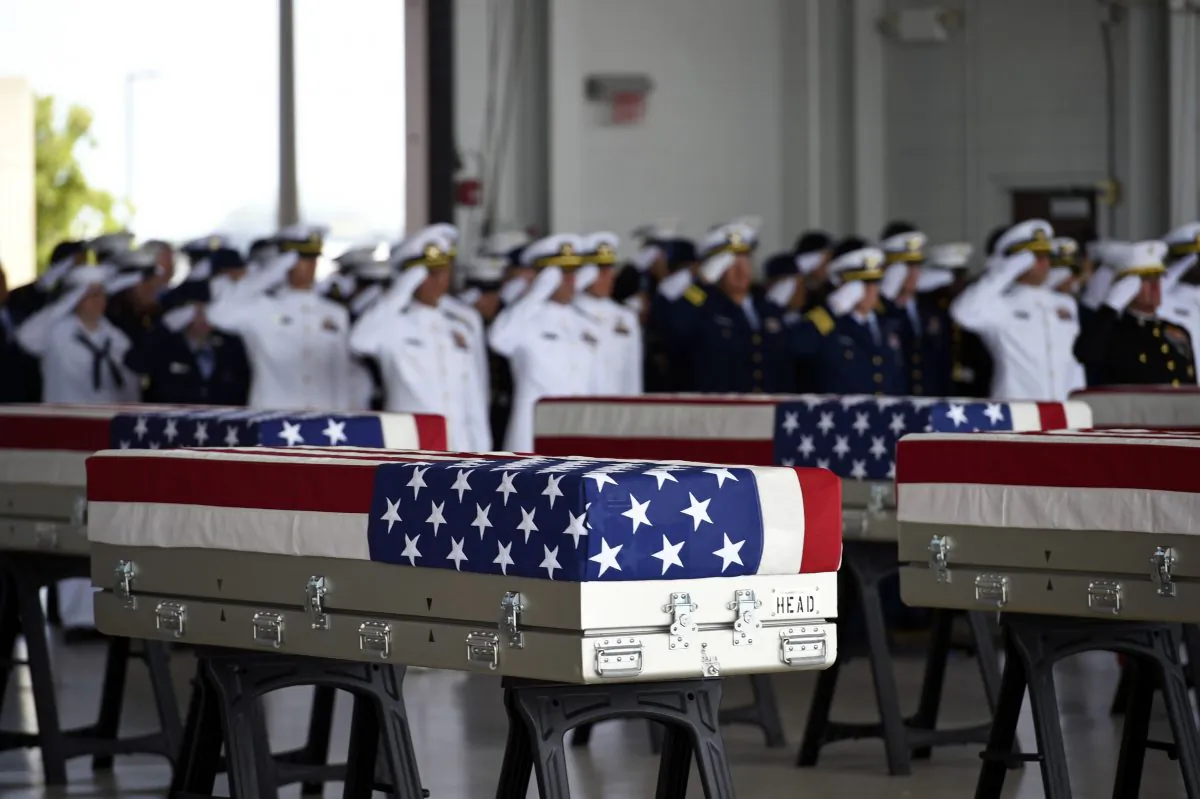 Flag-draped transfer cases with the remains of American soldiers repatriated from North Korea during a repatriation ceremony after arriving to Joint Base Pearl Harbor-Hickam, Honolulu, Hawaii, on Aug. 1, 2018. (RONEN ZILBERMAN/AFP/Getty Images)