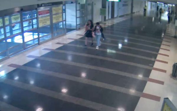 This photo provided by the Metropolitan Washington Airports Authority shows missing 12-year-old girl JinJing Ma with an unidentified person walking through the baggage/arrivals level at Ronald Reagan Washington National Airport, on Aug. 2, 2018. (Metropolitan Washington Airports via AP)