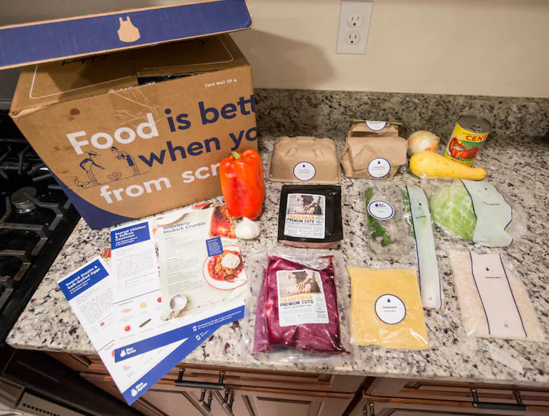 Items from a "family-plan" Blue Apron box are displayed on a kitchen counter on June 28, 2017 in Boston. (Scott Eisen/Getty Images)