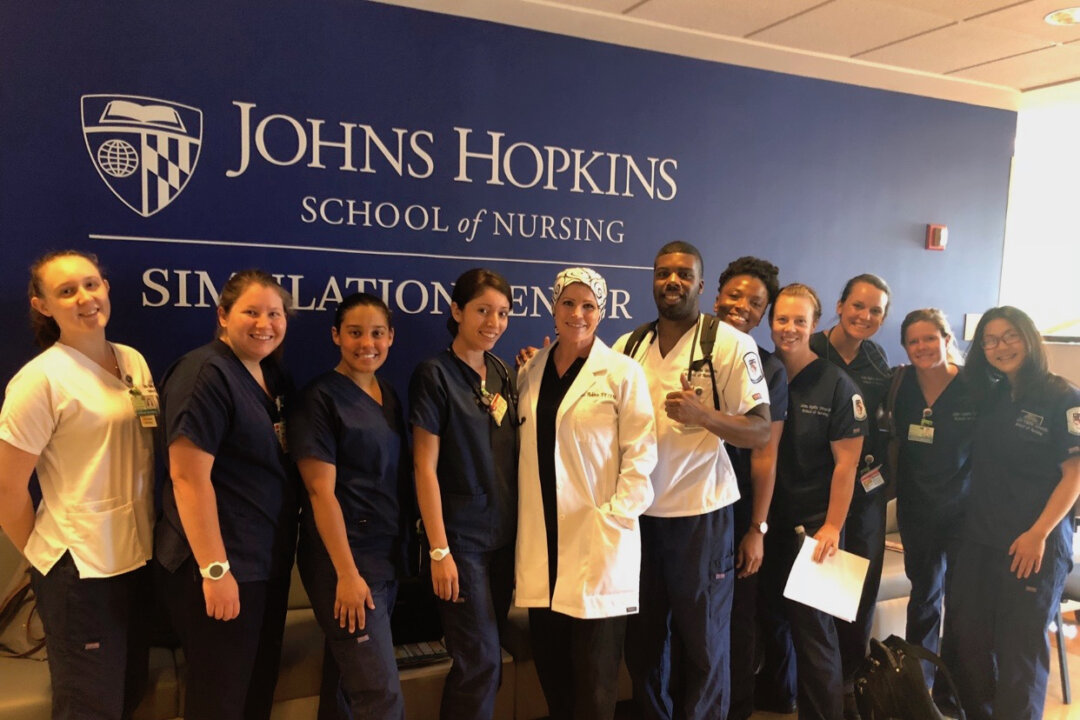 Tina Workman (middle in white) and her students after a simulation training. (Photo courtesy of Tina Workman)
