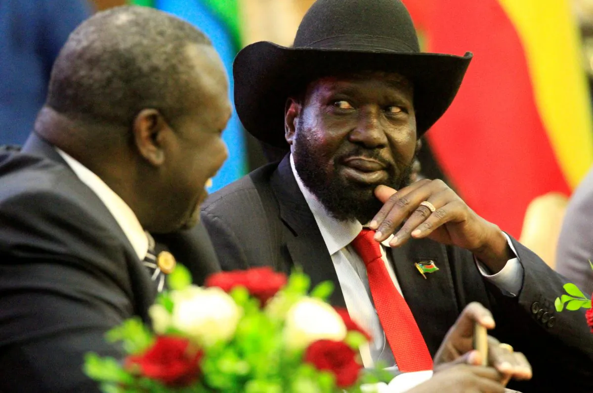 South Sudan's President Salva Kiir (R) talks to South Sudan's rebel leader Riek Machar as they sign a cease fire and power sharing agreement with in Khartoum, Sudan August 5, 2018. (Reuters/Mohamed Nureldin Abdallah)