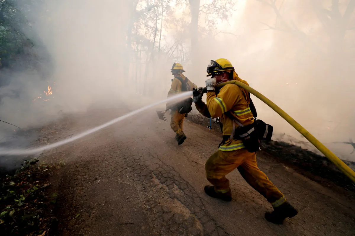 A firefighter knocks down hotspots to slow the spread of the Mendocino Complex fire in Lakeport, California on July 31, 2018. (Fred Greaves/Reuters)