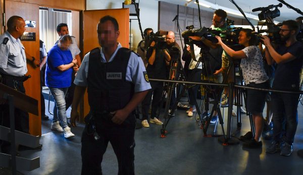 The defendants Berrin T. (L) leaves the courtroom after the pronouncement of her sentence at the district court in Freiburg, southern Germany, on August 7, 2018. - The court handed down lengthy jail sentences to a couple for repeatedly sexually abusing their young son and selling him to pedophiles online, in a shocking case that raised pointed questions about the competence of child protection services. (THOMAS KIENZLE/AFP/Getty Images)