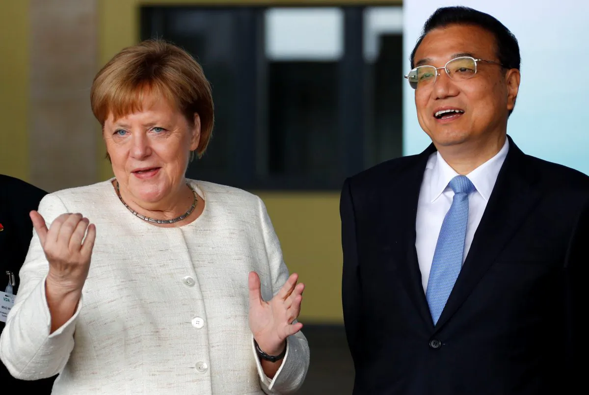 German Chancellor Angela Merkel (L) and Chinese Premier Li Keqiang arrive for a presentation of self-driving cars at the defunct historic Tempelhof Airport in Berlin, Germany, on July 10, 2018. (Fabrizio Bensch/AFP/Getty Images)