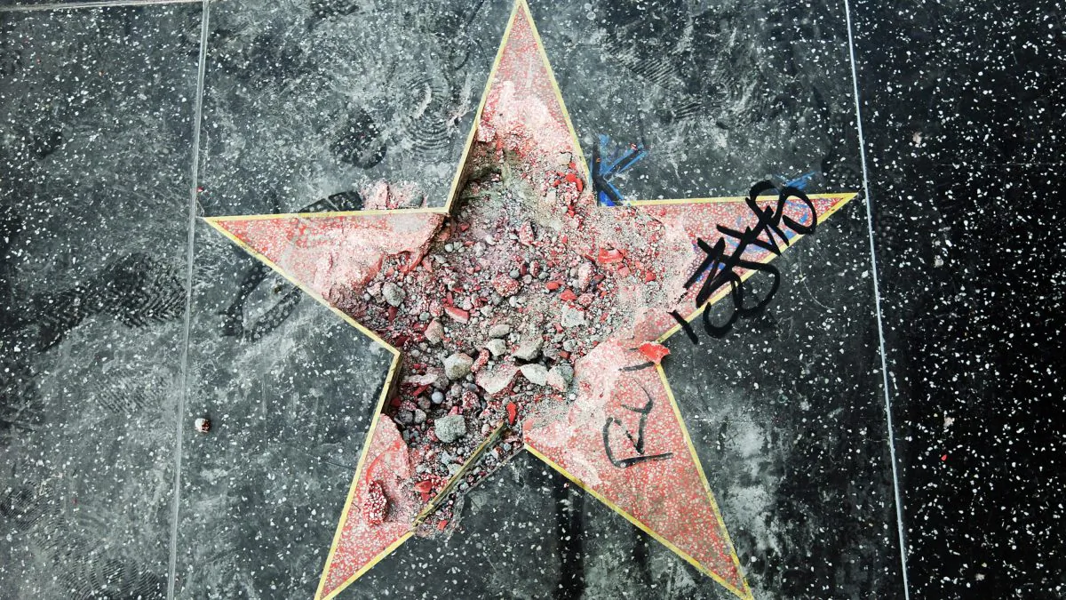 This photo shows Donald Trump's star on the Hollywood Walk of Fame that was vandalized Wednesday, July 25, 2018, in Los Angeles. Los Angeles police Officer Ray Brown said the vandalism was reported early Wednesday and someone was subsequently taken into custody. Authorities said a pickax was used in the vandalism. (AP Photo/Reed Saxon)