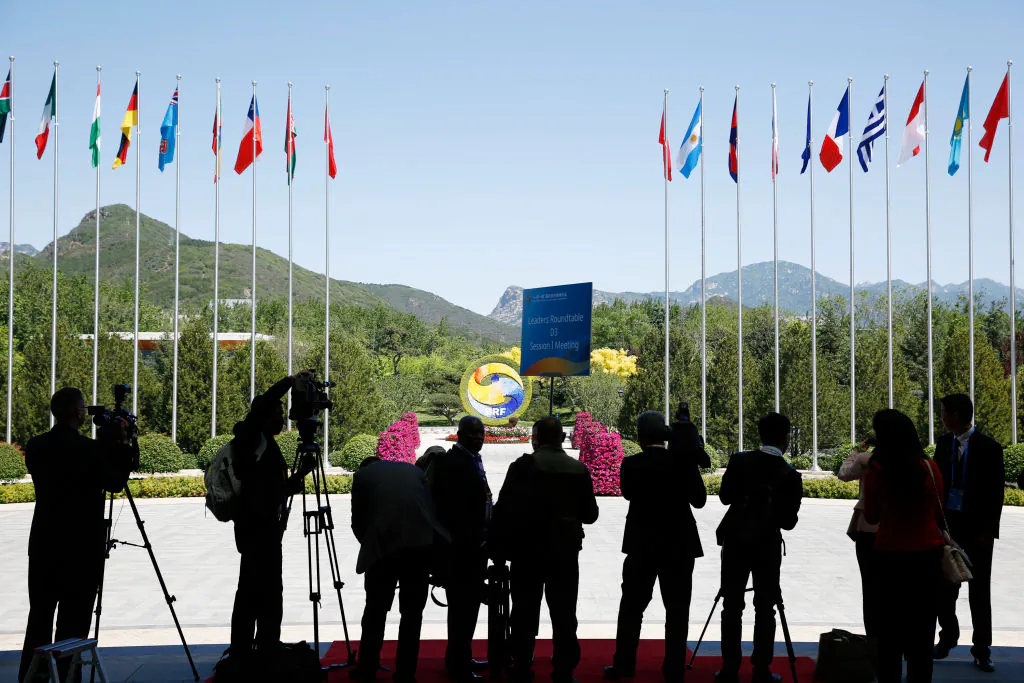 Journalists take pictures outside the venue of a summit at the Belt and Road Forum in Beijing on May 15, 2017 (Thomas Peter-Pool/Getty Images)