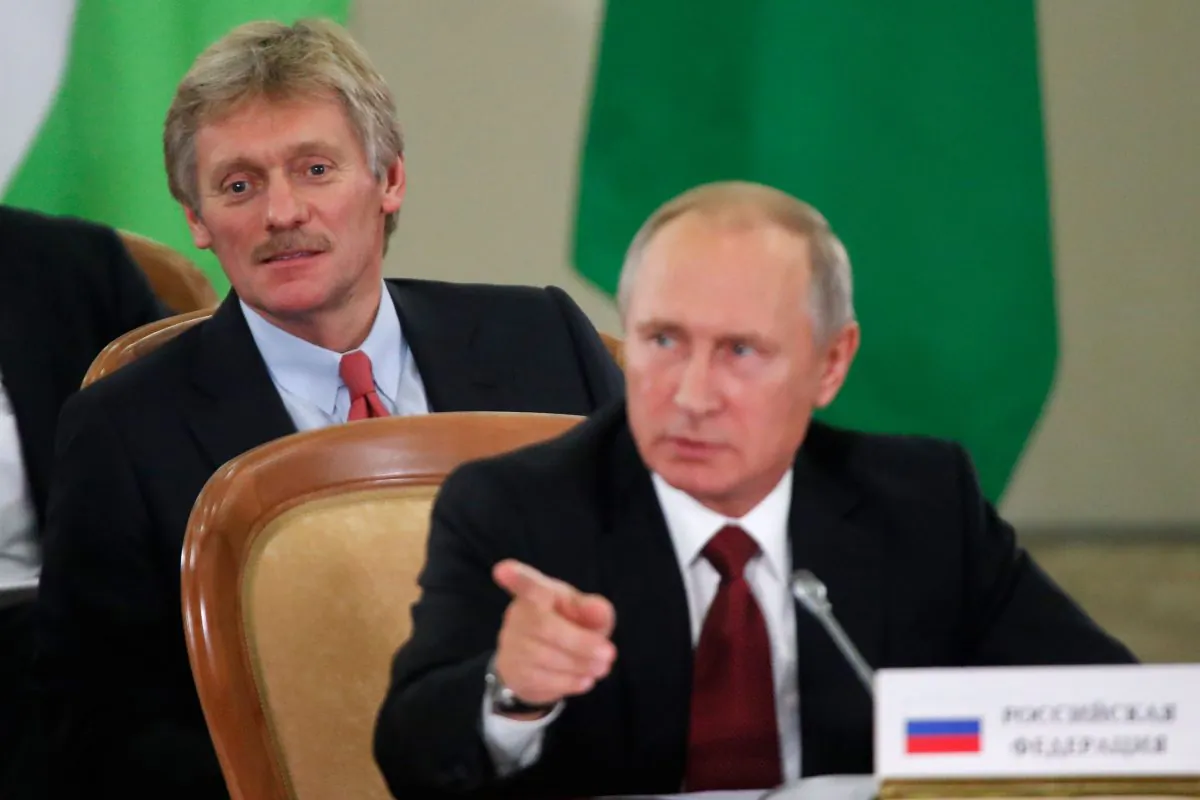 Russia's President Vladimir Putin (front) and Kremlin spokesman Dmitry Peskov attend a session of the Council of Heads of the Commonwealth of Independent States (CIS) in Sochi on Oct. 11, 2017. (Maxim Shemetov/AFP/Getty Images)