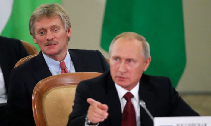 Russia's President Vladimir Putin (front) and Kremlin spokesman Dmitry Peskov attend a session of the Council of Heads of the Commonwealth of Independent States (CIS) in Sochi on Oct. 11, 2017. (Maxim Shemetov /AFP/Getty Images)