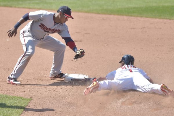 Cleveland Indians center fielder Greg Allen steals second base beside Minnesota Twins shortstop Jorge Polanco in the ninth inning.