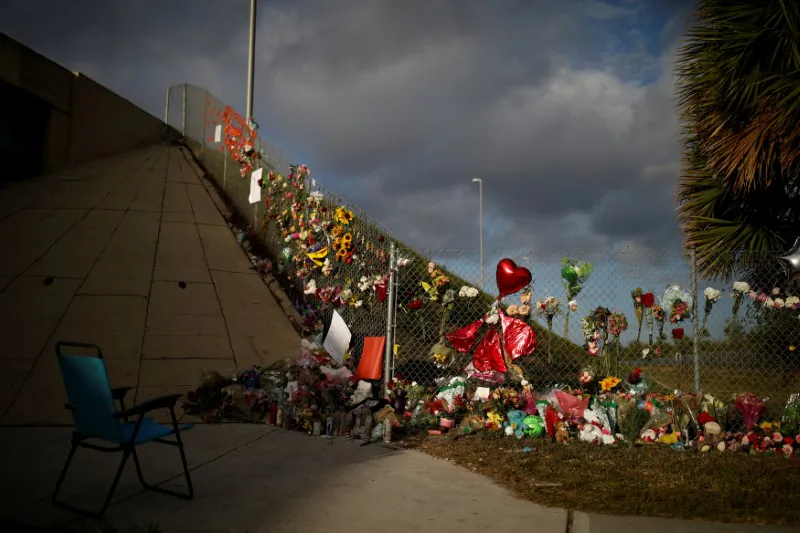 File photo: An empty chair is seen in front of flowers and mementoes placed on a fence to commemorate the victims of the mass shooting at Marjory Stoneman Douglas High School, in Parkland, Florida, U.S., February 20, 2018. (Reuters/Carlos Garcia Rawlins)