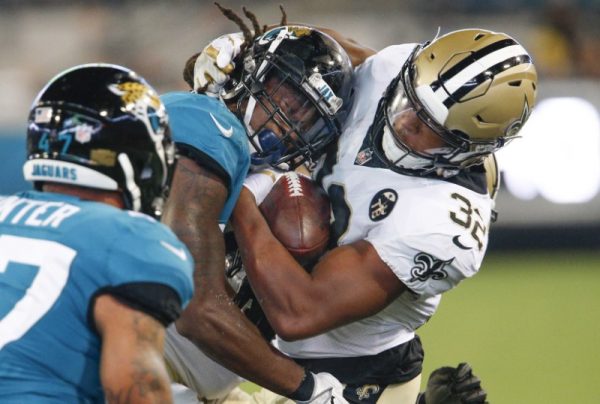 New Orleans Saints running back Jonathan Williams is hit by Jacksonville Jaguars defensive back Jarrod Wilson after a catch during the second half.