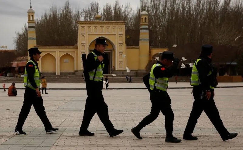 Police patrol walk in front of the Id Kah Mosque in the old city of Kashgar, in Xinjiang, China on March 22, 2017. (Reuters/Thomas Peter)