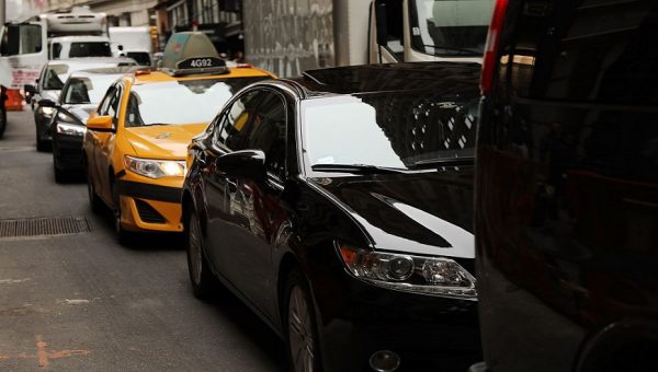 Cars drive through traffic in NYC.