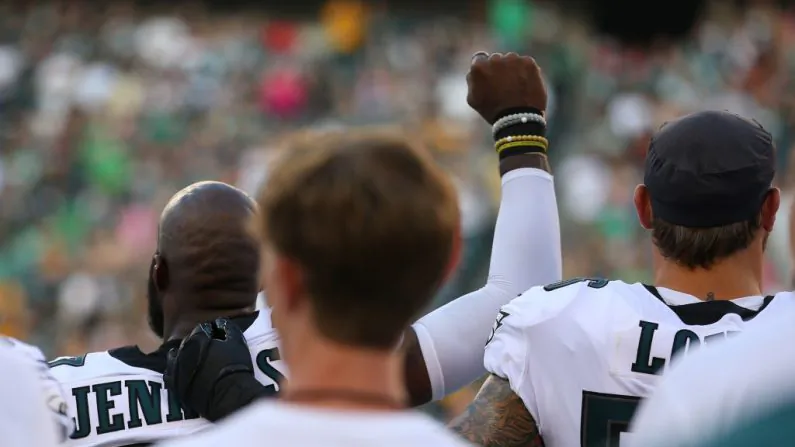 Malcolm Jenkins #27 of the Philadelphia Eagles raises his fist during the national anthem as Chris Long #56 puts his arm around him prior to the preseason game against the Pittsburgh Steelers at Lincoln Financial Field on Aug. 9, 2018 in Philadelphia, Pennsylvania. (Photo by Mitchell Leff/Getty Images)