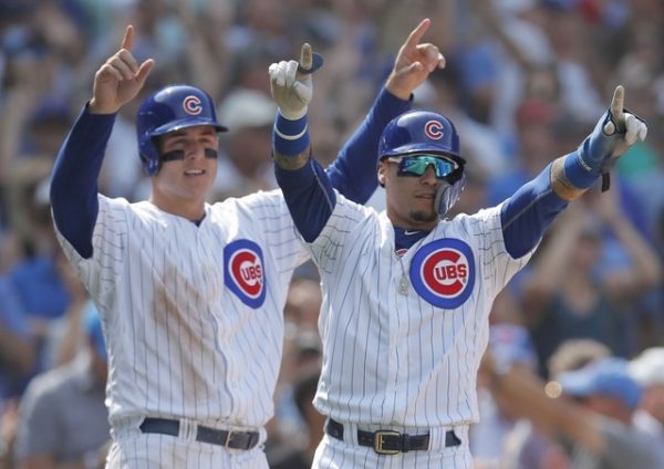 Chicago Cubs first baseman Anthony Rizzo, and Chicago Cubs second baseman Javier Baez celebrate after scoring two runs against the Washington Nationals during the sixth inning.