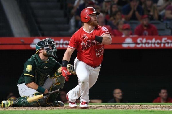 Los Angeles Angels right fielder Kole Calhoun hits a two-run home run in the third inning against the Oakland Athletics.