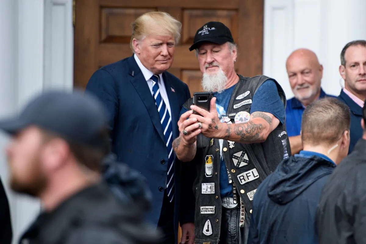 President Donald Trump takes a selfie with a supporter during a Bikers for Trump event at the Trump National Golf Club in Bedminster, New Jersey on Aug. 11, 2018. (BRENDAN SMIALOWSKI/AFP/Getty Images)