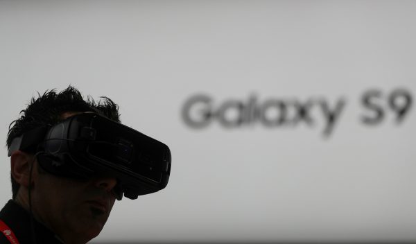 A man checks Samsung's Virtual Reality device at the Mobile World Congress.
