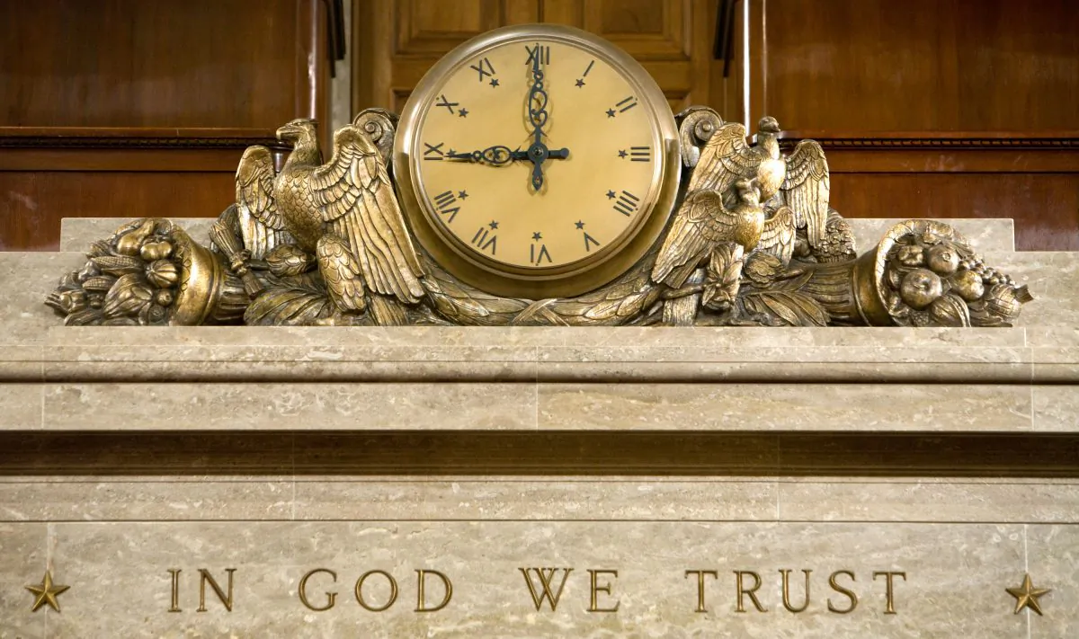 A clock and the motto "In God We Trust" over the Speaker's rostrum in the U.S. House of Representatives chamber on Dec. 8, 2008 in Washington. (Brendan Hoffman/Getty Images)