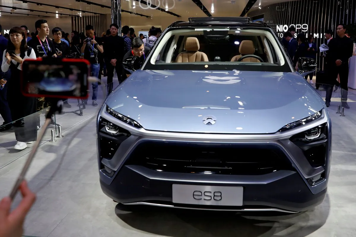 Visitors check NIO ES8 displayed during a media preview of the Auto China 2018 motor show in Beijing, China, on April 25, 2018. (Damir Sagolj/Reuters)