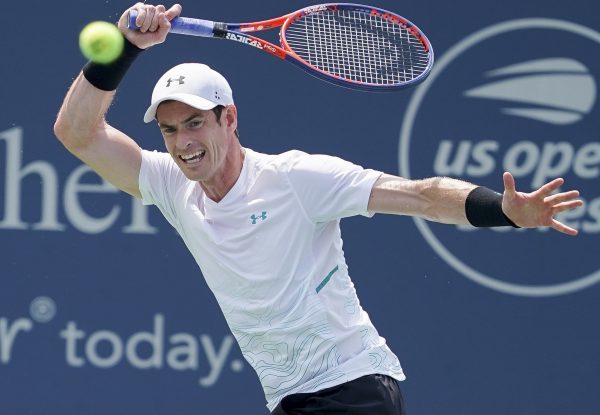 Andy Murray, of Great Britain, returns to Lucas Pouille, of France, in the first round at the Western and Southern Open, Monday, Aug. 13, 2018, in Mason, Ohio.