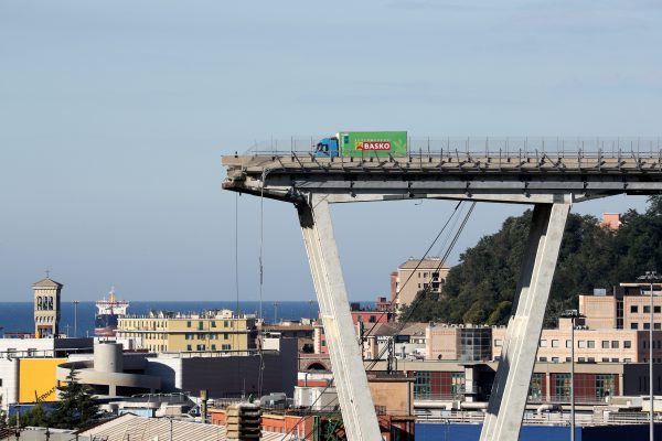 An abandoned truck sits atop a section of the collapsed bridge