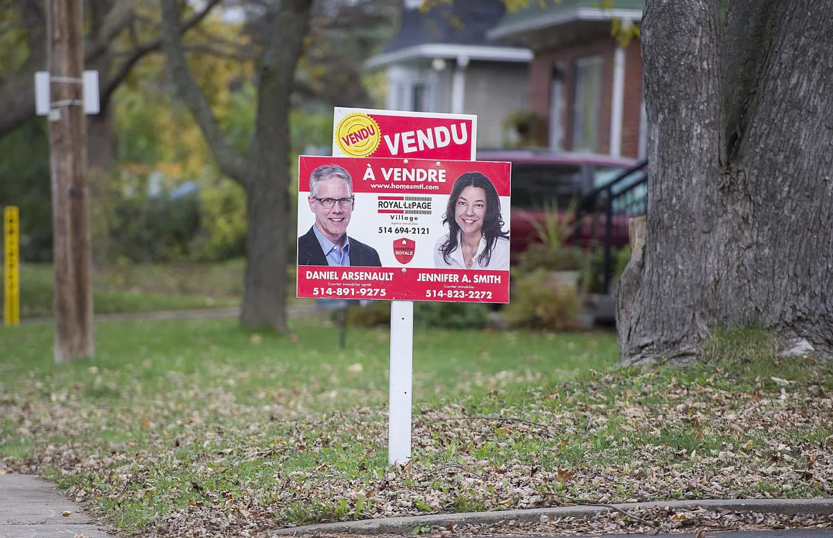 A sold sign is shown on the lawn of a residential property on the west island of Montreal in this file photo. (Graham Hughes/The Canadian Press)