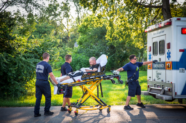 Paramedics load a man into an ambulance after they revived him with opioid-blocker Narcan in the Drexel neighborhood of Dayton, Ohio, on Aug. 3, 2017. (Benjamin Chasteen/The Epoch Times)