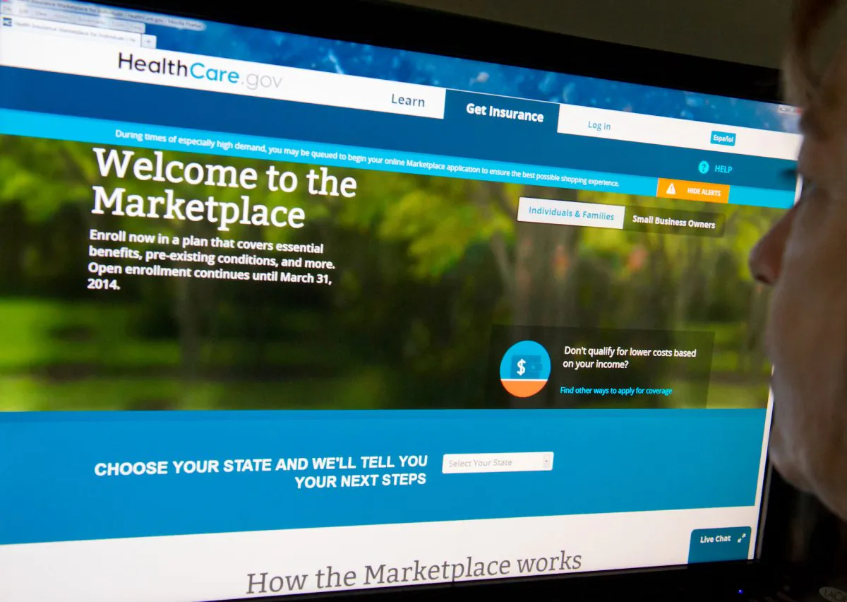 A woman reads the HealthCare.gov insurance marketplace  website in Washington, on Dec. 2, 2013. (Karen Bleier/AFP/Getty Images)