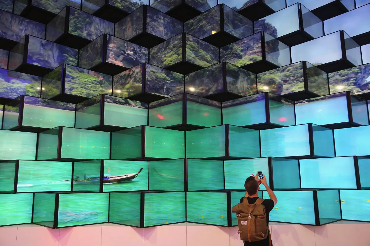 A visitor looks at LED TVs at the 2014 IFA home electronics and appliances trade fair in Berlin on Sept. 5, 2014. (Sean Gallup/Getty Images)