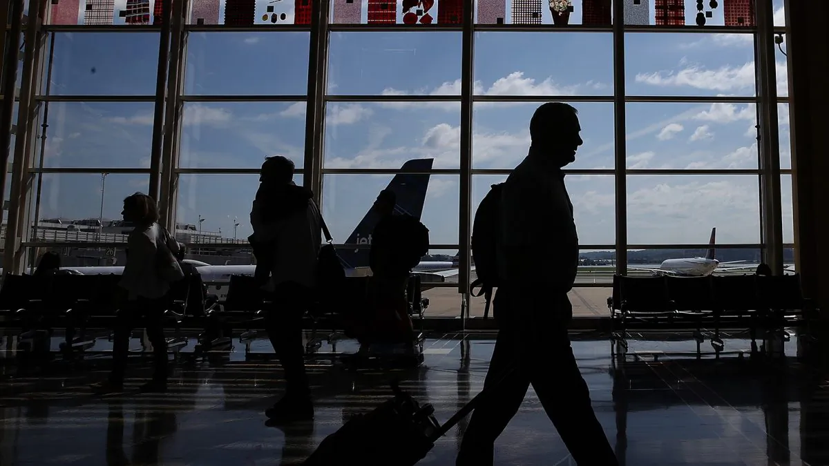 Travelers walk to their gates in the concourse of Reagan National Airport on June 29, 2018 in Washington, D.C. (Win McNamee/Getty Images)