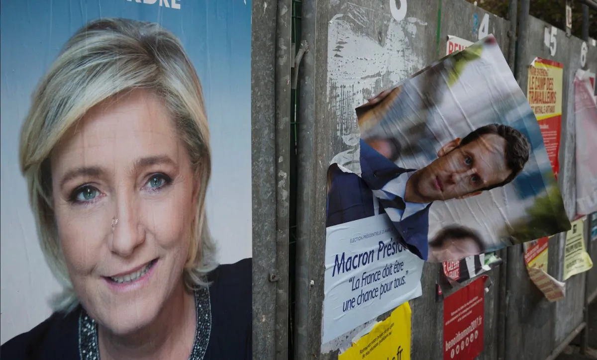 Marine Le Pen, a prominent figure on the political far-right in France, has been cut from the roster of speakers at the tech event Web Summit. Le Pen is featured on a campaign poster in Henin-Beaumont, France on April 24, 2017. (Joel Saget/AFP/Getty Images)