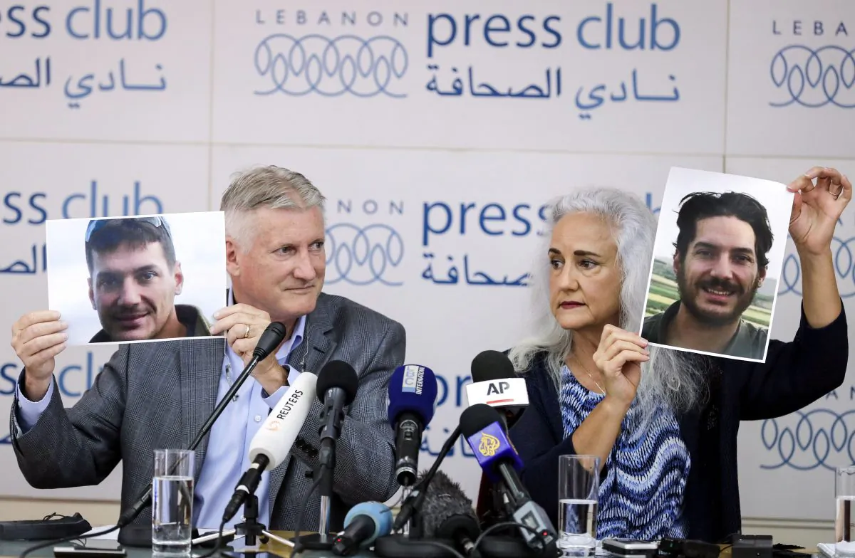 Marc (L) and Debra Tice, parents of U.S. journalist Austin Tice who was kidnapped in Syria in 2012, hold portraits of him during a press conference in the Lebanese capital Beirut on July 20, 2017. (JOSEPH EID/AFP/Getty Images)