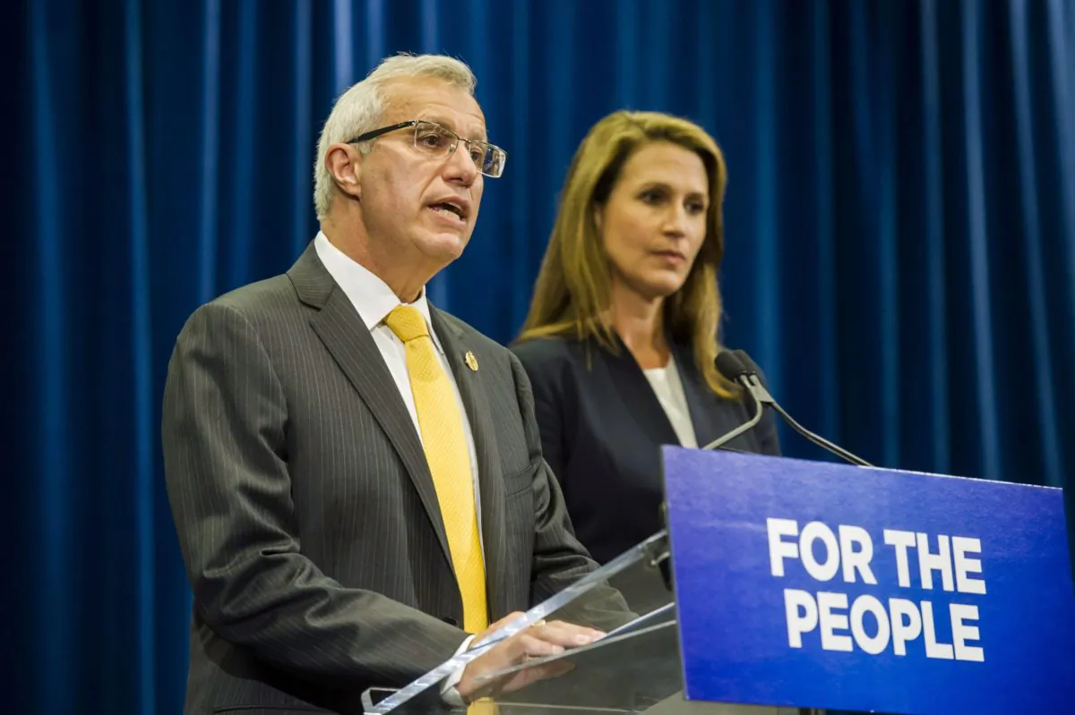 Ontario's Minister of Finance Vic Fideli and Attorney General Caroline Mulroney deliver remarks following an announcement on the provinces's cannabis retail model, in Toronto on Aug. 13, 2018. (THE CANADIAN PRESS/Christopher Katsarov)